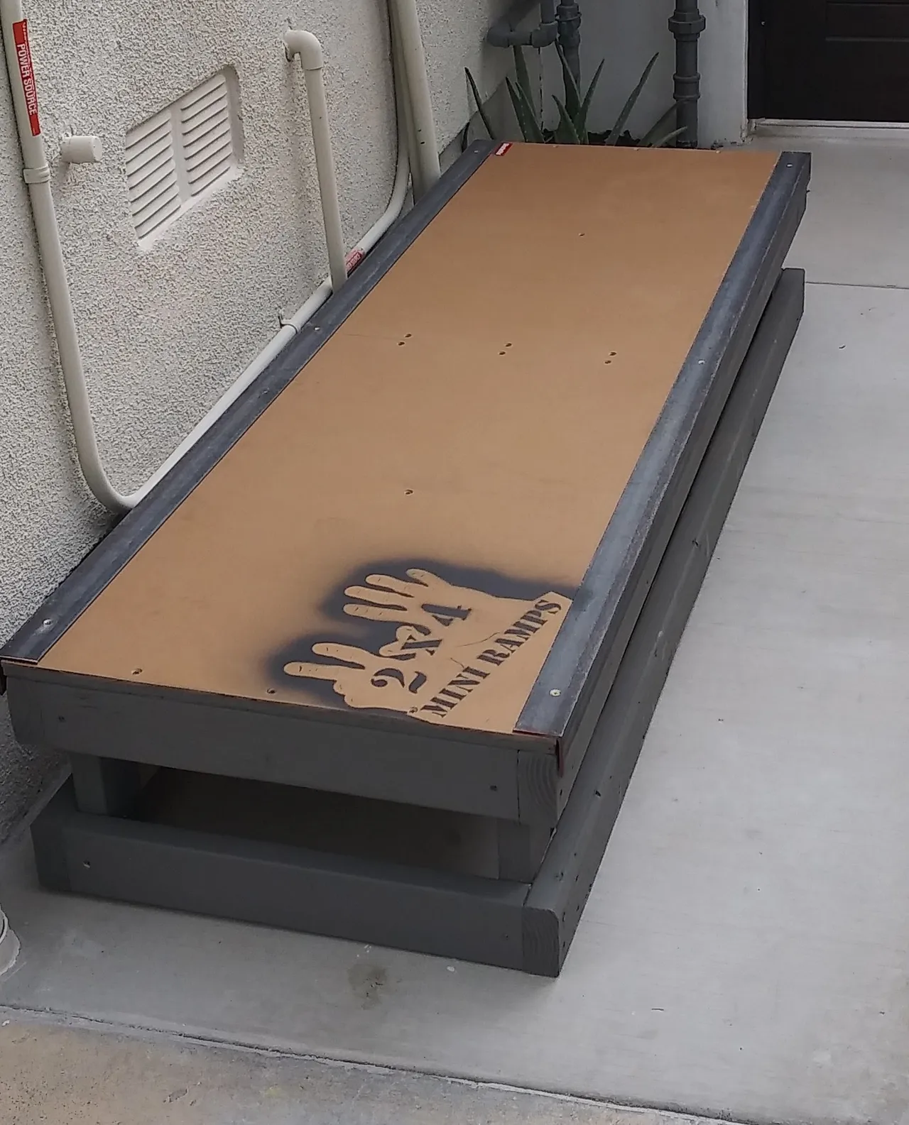 One foot high by six foot long grind box on concrete, front view